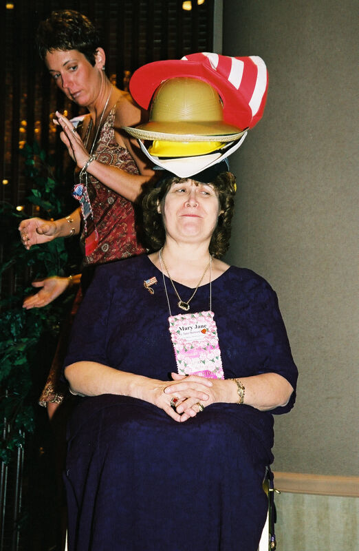 Mary Jane Johnson Wearing Multiple Hats at Convention Officers' Luncheon Photograph 7, July 4-8, 2002 (Image)