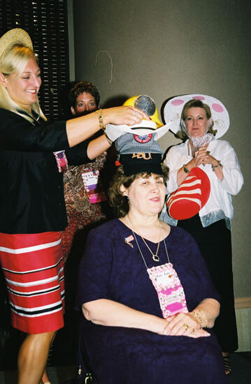 Kris Bridges Placing Hat on Mary Jane Johnson at Convention Officers' Luncheon Photograph, July 4-8, 2002 (image)