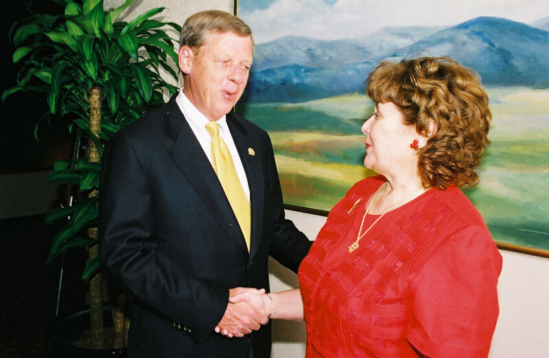 Johnny Isakson and Mary Jane Johnson Shaking Hands at Convention Photograph 2, July 4-8, 2002 (Image)
