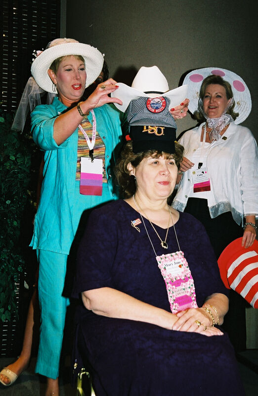 Mary Jane Johnson Wearing Multiple Hats at Convention Officers' Luncheon Photograph 2, July 4-8, 2002 (Image)