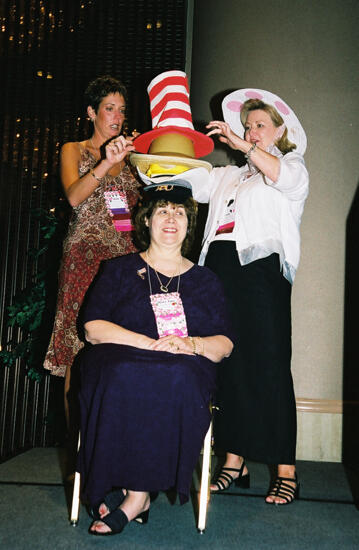 Wooley and Moore Placing Hat on Johnson at Convention Officers' Luncheon Photograph 1, July 4-8, 2002 (image)