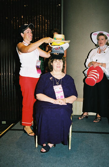 Mary Beth Straguzzi Placing Hat on Mary Jane Johnson at Convention Officers' Luncheon Photograph, July 4-8, 2002 (image)