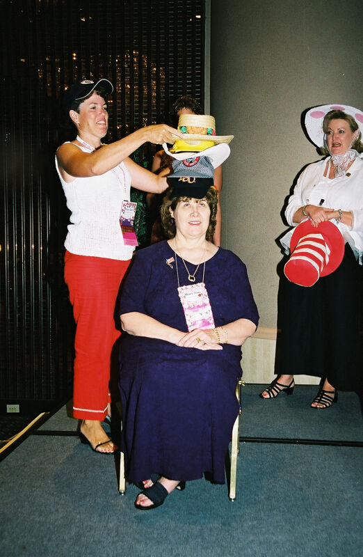 Mary Beth Straguzzi Placing Hat on Mary Jane Johnson at Convention Officers' Luncheon Photograph, July 4-8, 2002 (Image)