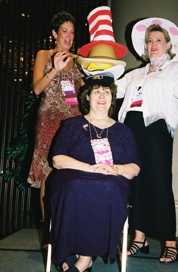 Wooley and Moore Placing Hat on Johnson at Convention Officers' Luncheon Photograph 2, July 4-8, 2002 (image)