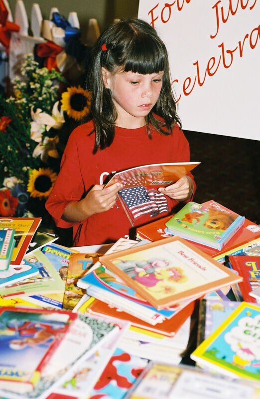Young Girl With Books at Convention Photograph 1, July 4-8, 2002 (Image)