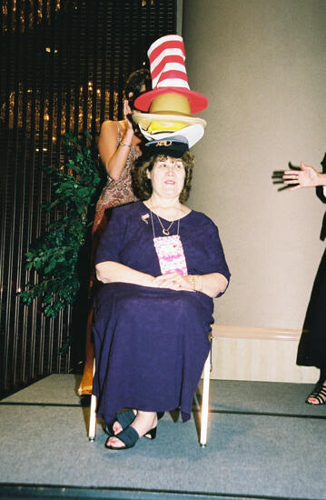 Mary Jane Johnson Wearing Multiple Hats at Convention Officers' Luncheon Photograph 4, July 4-8, 2002 (image)