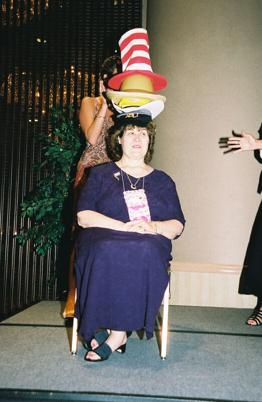 Mary Jane Johnson Wearing Multiple Hats at Convention Officers' Luncheon Photograph 4, July 4-8, 2002 (Image)