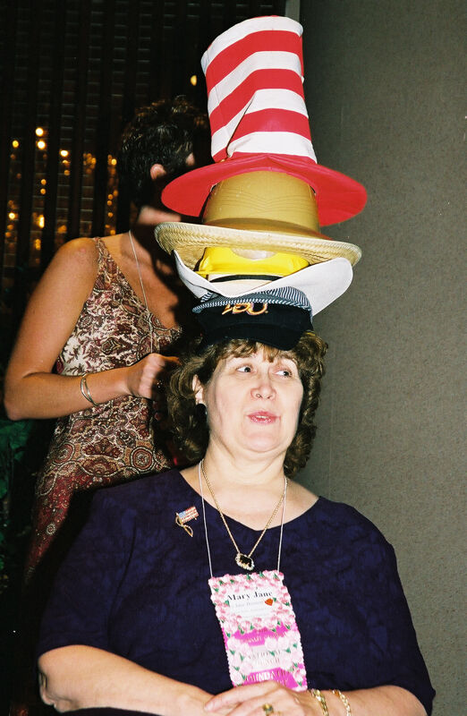 Mary Jane Johnson Wearing Multiple Hats at Convention Officers' Luncheon Photograph 5, July 4-8, 2002 (Image)