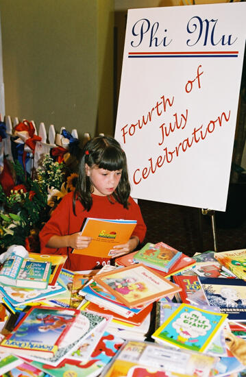 Young Girl With Books at Convention Photograph 3, July 4-8, 2002 (image)