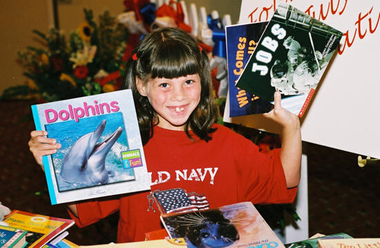 Young Girl With Books at Convention Photograph 5, July 4-8, 2002 (image)