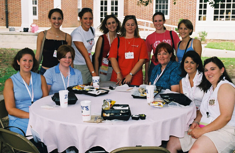 Table of 11 Outside at Wesleyan College During Convention Photograph 1, July 4-8, 2002 (Image)