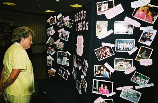 Unidentified Phi Mu Examining Convention Exhibit Photograph, July 4-8, 2002 (image)