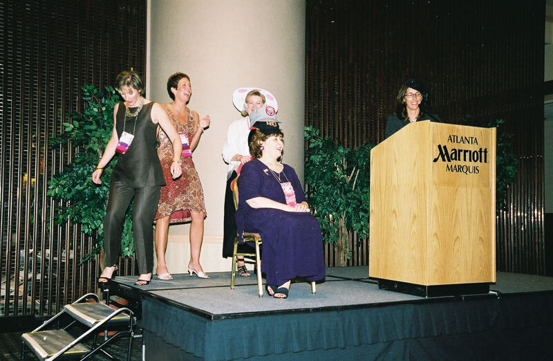 Mary Jane Johnson Wearing Multiple Hats at Convention Officers' Luncheon Photograph 1, July 4-8, 2002 (Image)