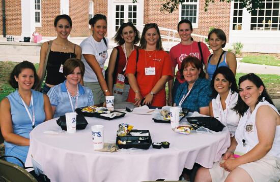 Table of 11 Outside at Wesleyan College During Convention Photograph 3, July 4-8, 2002 (image)