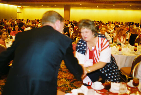 Johnny Isakson Greeting Kathy Williams at Convention Welcome Dinner Photograph, July 4, 2002 (image)