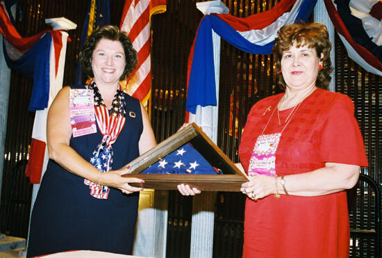 Frances Mitchelson and Mary Jane Johnson With American Flag at Convention Welcome Dinner Photograph 3, July 4, 2002 (image)