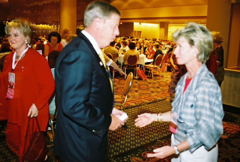 Johnny Isakson Talking to Unidentified at Convention Welcome Dinner Photograph 1, July 4, 2002 (Image)