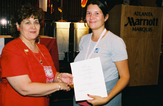 Mary Jane Johnson and Austin Alumnae Chapter Member With Certificate at Convention Photograph 1, July 4-8, 2002 (image)