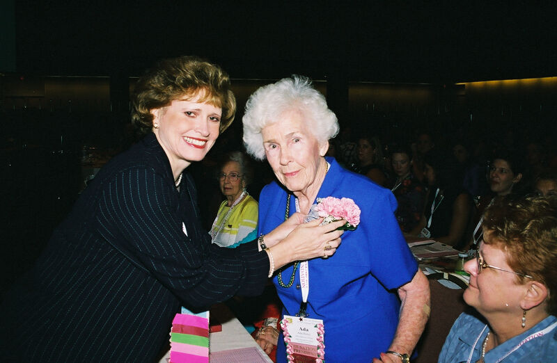 Kathie Garland Pinning Corsage on Ada Henry at Convention Photograph, July 4-8, 2002 (Image)
