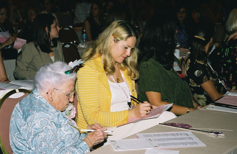 Leona Hughes and Unidentified Taking Notes in Convention Session Photograph, July 4-8, 2002 (Image)