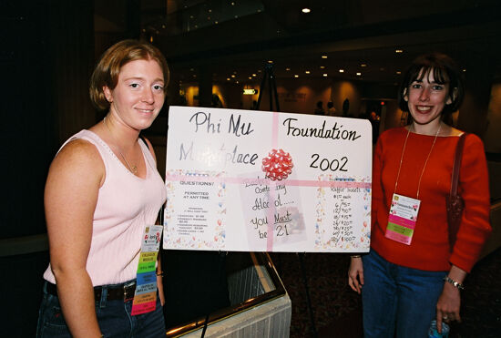 April and Samantha by Phi Mu Foundation Sign at Convention Photograph, July 4-8, 2002 (image)