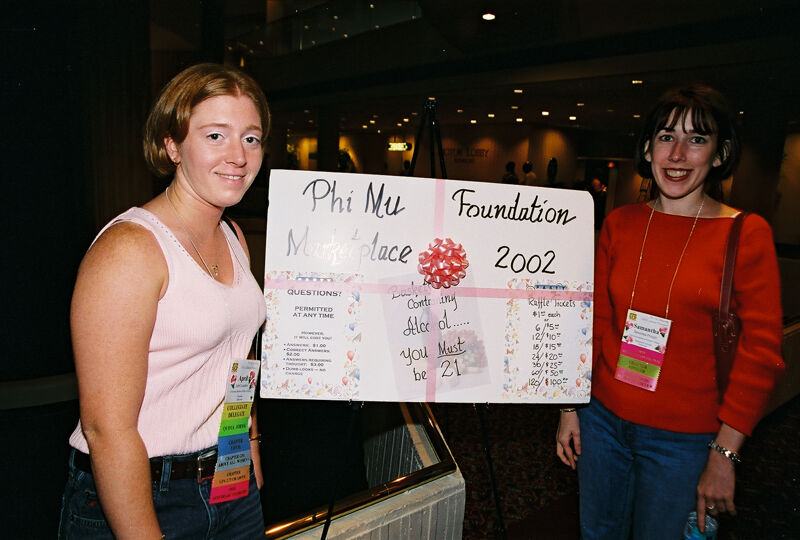 April and Samantha by Phi Mu Foundation Sign at Convention Photograph, July 4-8, 2002 (Image)