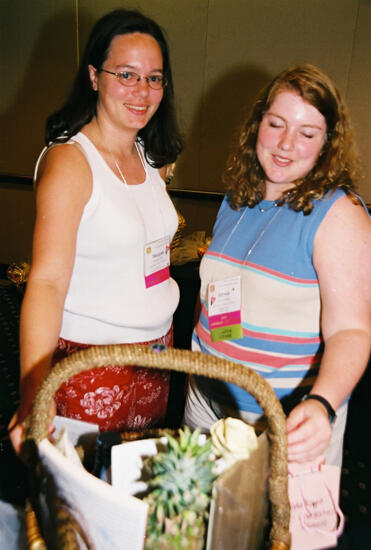 Alysia and Unidentified With Basket at Convention Photograph 2, July 4-8, 2002 (image)