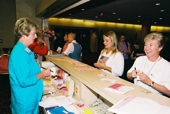 Phi Mus at Information Desk During Convention Photograph, July 4-8, 2002 (image)