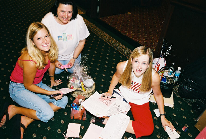 Three Phi Mus Writing Notes at Convention Photograph, July 4-8, 2002 (Image)