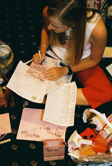 Unidentified Phi Mu Writing Notes at Convention Photograph, July 4-8, 2002 (image)