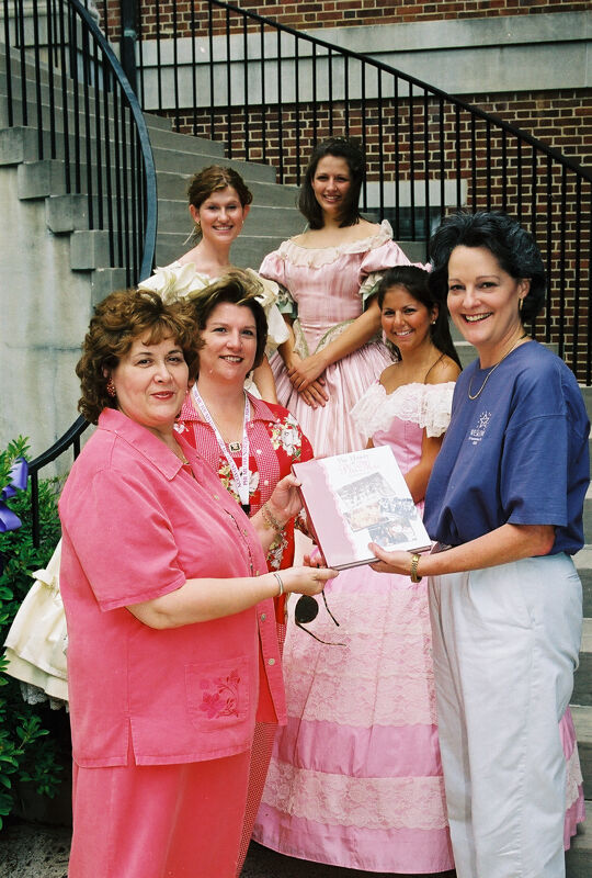 Johnson, Mitchelson, and Others With History Book at Convention Photograph 2, July 4-8, 2002 (Image)