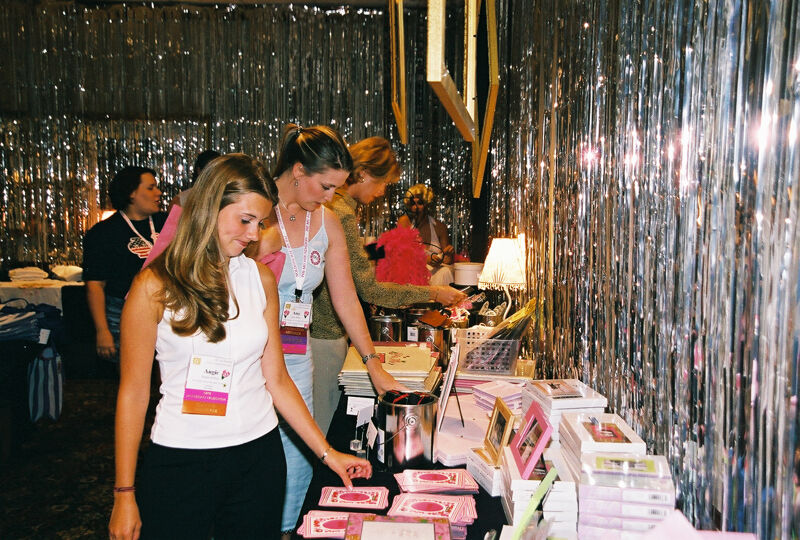Phi Mus Examining Merchandise at Convention Photograph 2, July 4-8, 2002 (Image)