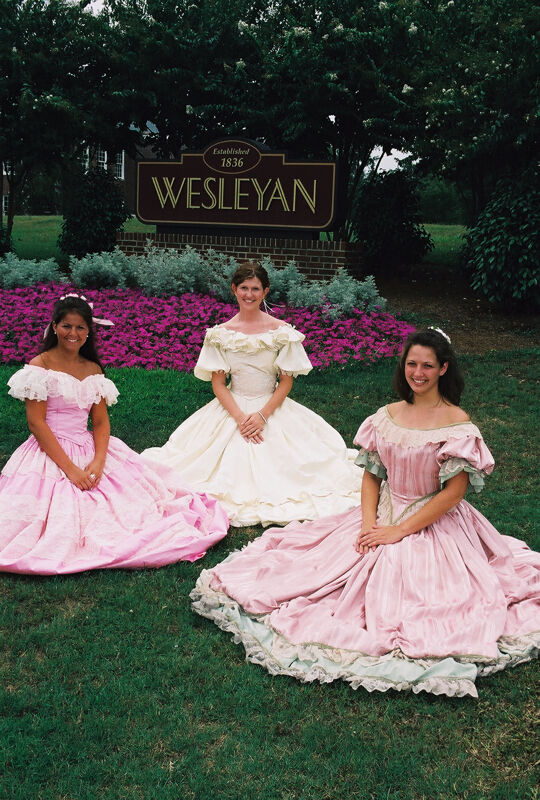 Three Phi Mus in Period Dress by Wesleyan Sign at Convention Photograph 3, July 4-8, 2002 (Image)