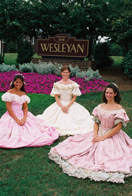 Three Phi Mus in Period Dress by Wesleyan Sign at Convention Photograph 4, July 4-8, 2002 (Image)