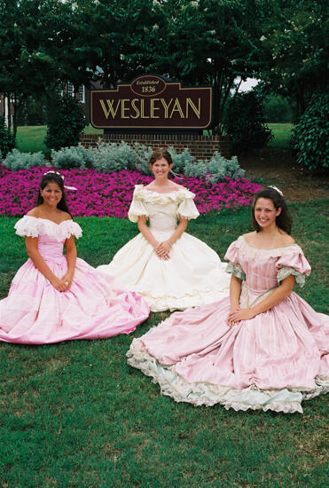 Three Phi Mus in Period Dress by Wesleyan Sign at Convention Photograph 1, July 4-8, 2002 (image)