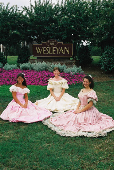 Three Phi Mus in Period Dress by Wesleyan Sign at Convention Photograph 7, July 4-8, 2002 (image)