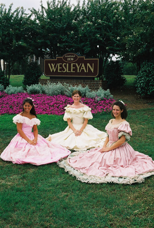 Three Phi Mus in Period Dress by Wesleyan Sign at Convention Photograph 7, July 4-8, 2002 (Image)