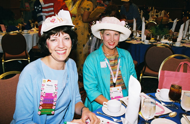 Marcie Helmke and Nancy Carpenter Wearing Hats at Convention Officers' Luncheon Photograph, July 4-8, 2002 (Image)