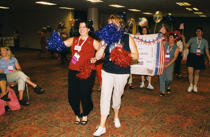 Molly Sorenson and Unidentified Phi Mu Leading Area I Alumnae in Convention Patriotic Parade Photograph, July 4, 2002 (Image)