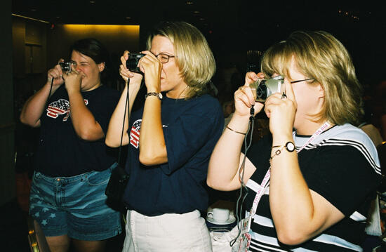 Three Phi Mus Taking Pictures at Convention Photograph, July 4-8, 2002 (image)