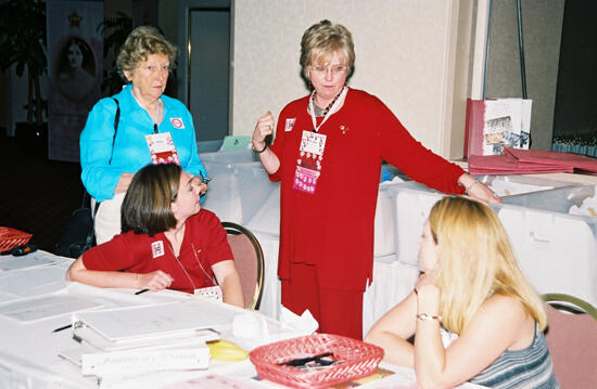 Rawson, Lewis, and Two Unidentified Phi Mus During Convention Registration Photograph, July 4-8, 2002 (image)