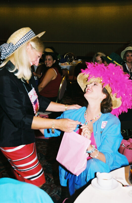 Kris Bridges Presenting Gift to Susan Kendricks at Convention Officers' Luncheon Photograph, July 4-8, 2002 (Image)