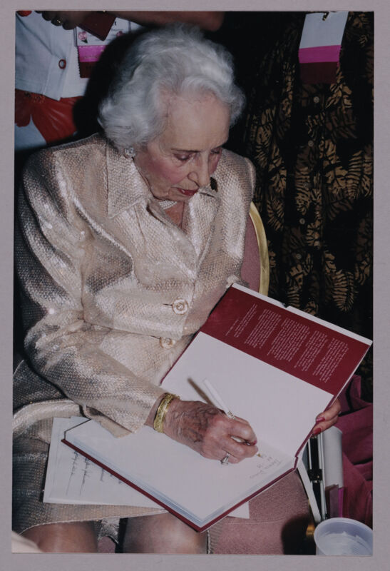 Polly Cowherd Signing Book at Convention Photograph, July 4-8, 2002 (Image)