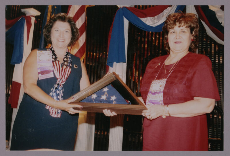Frances Mitchelson and Mary Jane Johnson With American Flag at Convention Welcome Dinner Photograph 1, July 4, 2002 (Image)