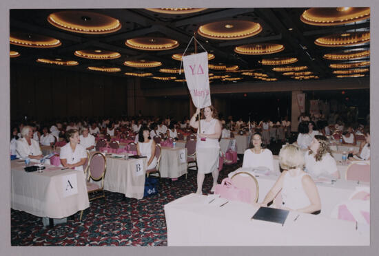 Sue Pero Carrying Upsilon Delta Chapter Banner at Convention Photograph 2, July 4-8, 2002 (image)