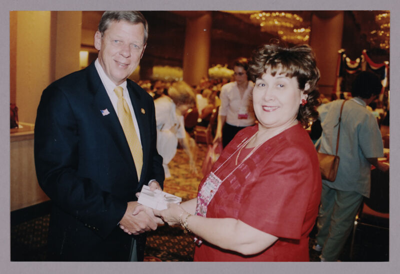 Johnny Isakson and Mary Jane Johnson Shaking Hands at Convention Photograph 1, July 4-8, 2002 (Image)
