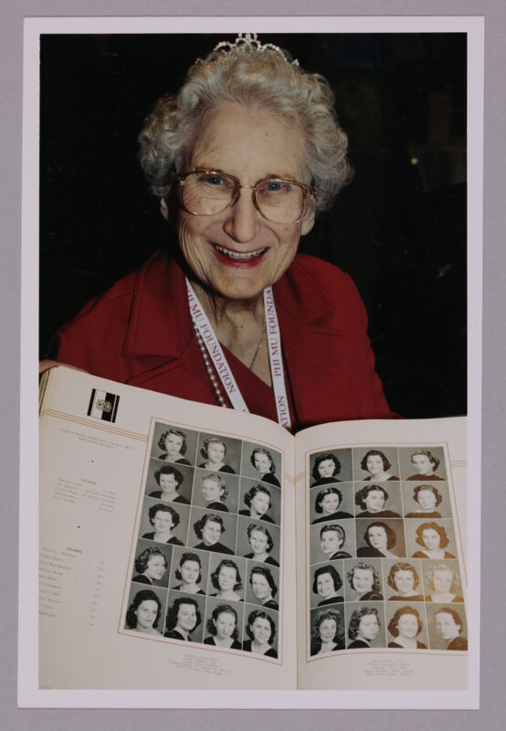 Anne Nelson With Old Yearbook at Convention Photograph 1, July 4-8, 2002 (Image)