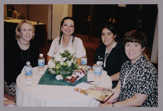 Delta Phi Chapter Members at Convention Table Photograph, July 4-8, 2002 (image)