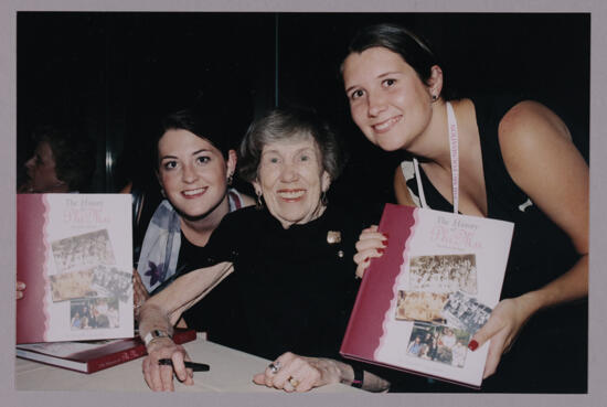 Becky Peterson and Two Phi Mus With History Books at Convention Photograph, July 4-8, 2002 (image)