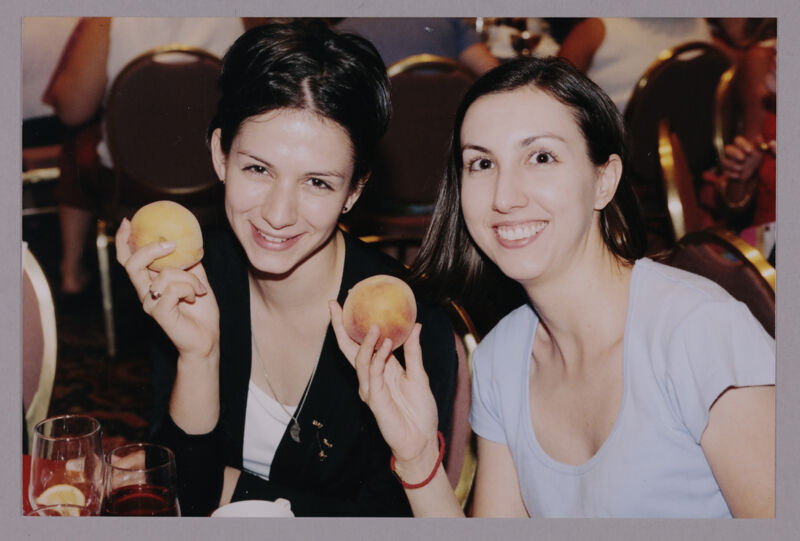 Two Phi Mus Holding Peaches at Convention Photograph 1, July 4-8, 2002 (Image)